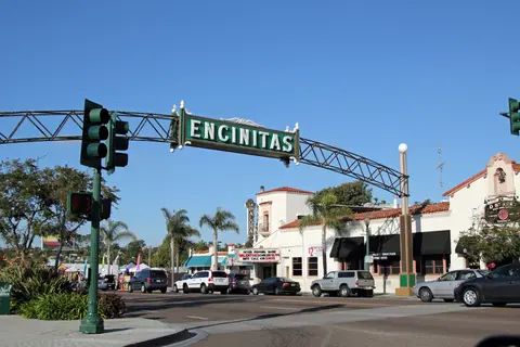 The Encinitas welcome arch over the main street, with cars parked along the curb